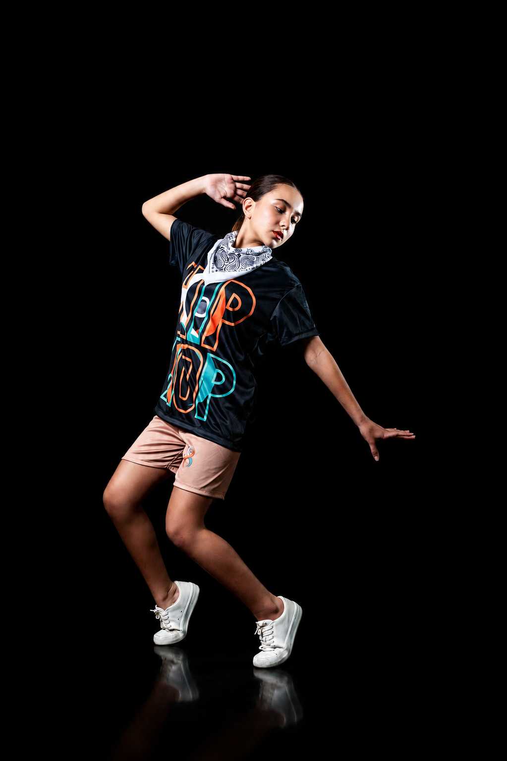 A dancer mid-performance on stage